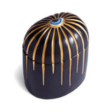 Dark blue cylinder candle with one wick posed with its eye motif topper
