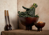 Set of 2 Alhambra hand-carved, fine smoked ash bowls floating on stacked wood pedestal with a brass base. Alhambra serving utensil set.